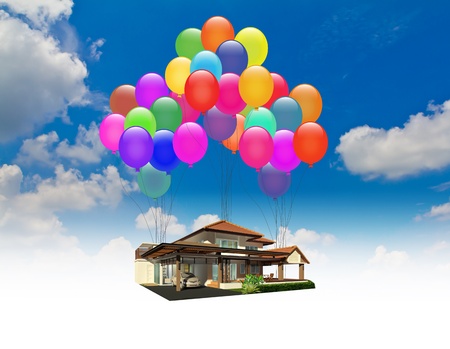 A house lifted by Balloons over blue skyの写真素材