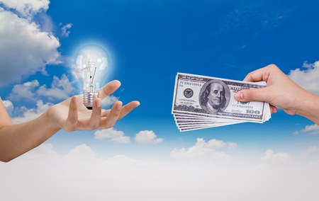 Hand exchange Idea (Bulb)with Dollar over blue skyの写真素材