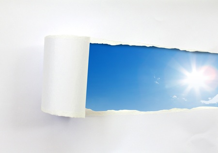 Ripped paper and blue skyの写真素材