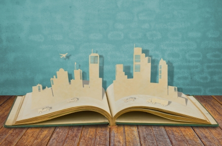 Paper cut of  cities with car and plane on old bookの写真素材