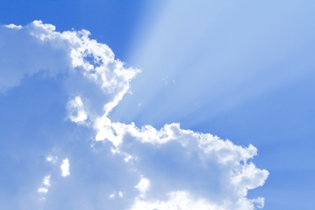 Blue sky with sun and beautiful cloudsの写真素材