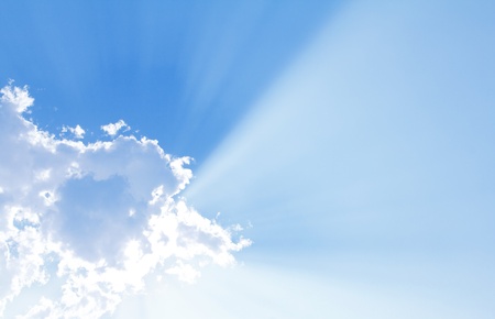 Blue sky with sun and beautiful cloudsの写真素材