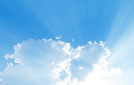 Blue sky with sun and beautiful cloudsの写真素材