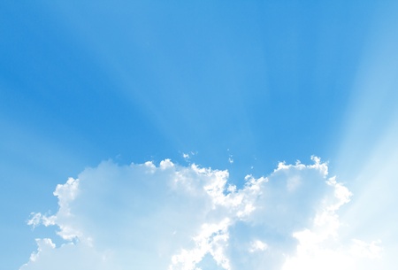 Blue sky with sun and beautiful cloudsの写真素材