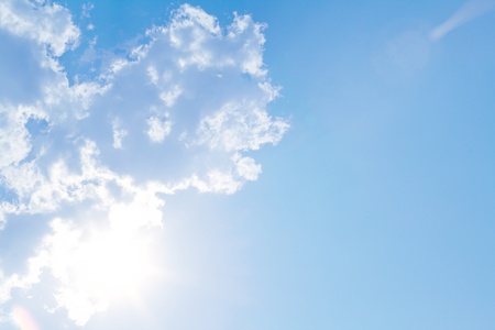 Blue sky with sun and beautiful cloudsの写真素材