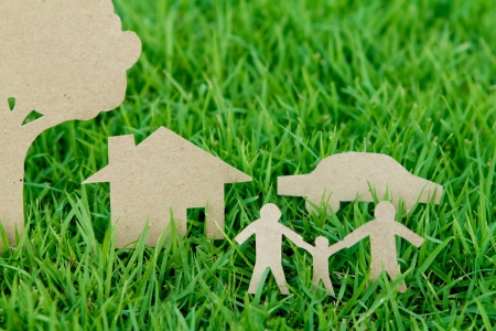 Paper cut of family with house , tree and car on fresh spring green grassの写真素材