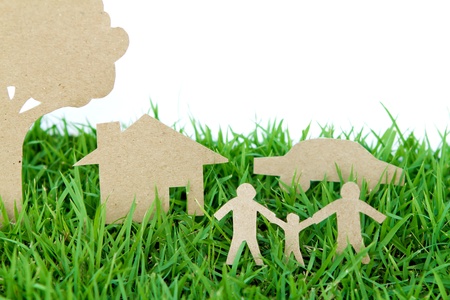 Paper cut of family with house , tree and car on fresh spring green grassの写真素材