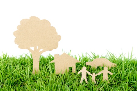Paper cut of family with house , tree and car on fresh spring green grassの写真素材