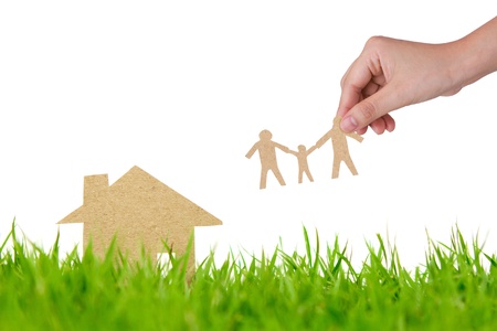 Paper cut of house on fresh spring green grassの写真素材