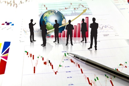 Silhouettes of business and business graph with earth (Elements of this image furnished by NASA)の写真素材