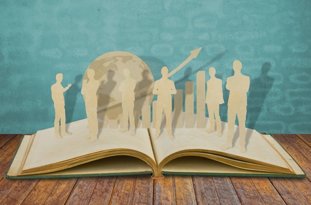 Paper cut of  business man  on old bookの写真素材