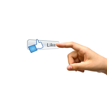 Hand pushing a Like button on a touch screen interface