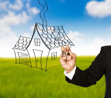 Business hand with pen drawing a houseの写真素材