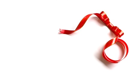 Shiny red ribbon on white background with copy space.の写真素材