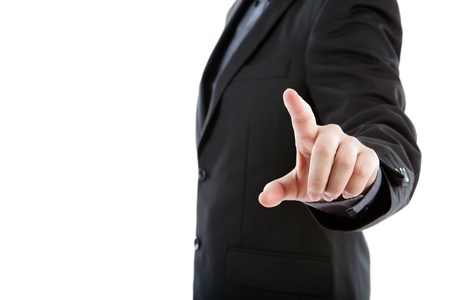 Business man touching an imaginary screen against white backgroundの写真素材