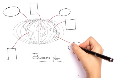 Businessman drawing the world map of business plan  in a whiteboardの写真素材