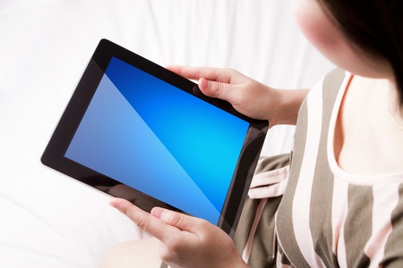 Woman reading the touch screen deviceの写真素材