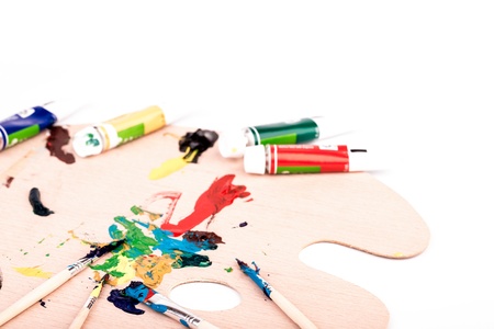 Wooden art palette with paint  brush on white backgroundの写真素材