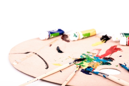 Wooden art palette with paint  brush on white backgroundの写真素材