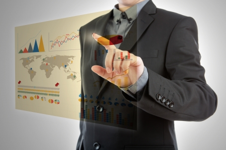 Business man pressing high tech type of modern graph on a virtual backgroundの写真素材
