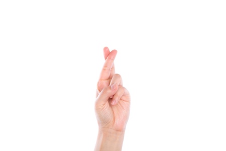 Finger crossed hand sign isolated on white backgroundの写真素材