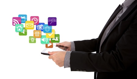 Business man using a touch screen device  with colorful application icons against white backgroundの写真素材