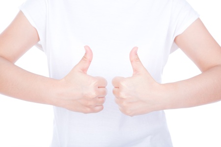 Two women hands showing thumbs up sign against white backgroundの写真素材