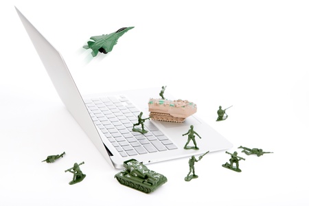 Computer security concept :  soldiers,tank,plane  are guarding a laptop from viruses, spyware and hackerの写真素材