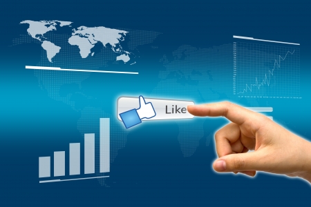 Business hand pushing a Like button on a touch screen interfaceの写真素材