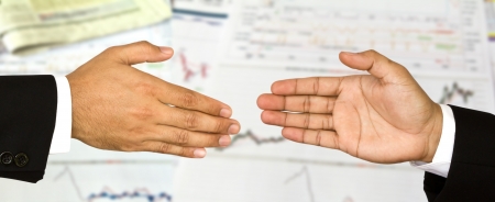 Two business male hands about to shake hands, over white backgroundの写真素材