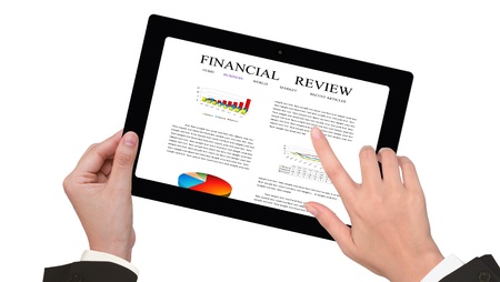 Female business person hands writing on financial review on the touch screen deviceの写真素材