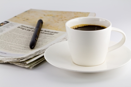 A cup of coffee and a newspaperの写真素材