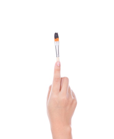 Woman hand with paintbrush isolated on white backgroundの写真素材