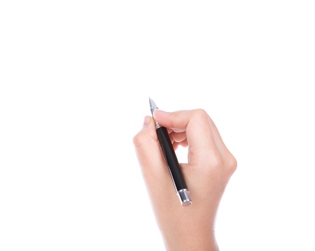 Woman  hand with pen on a white backgroundの写真素材