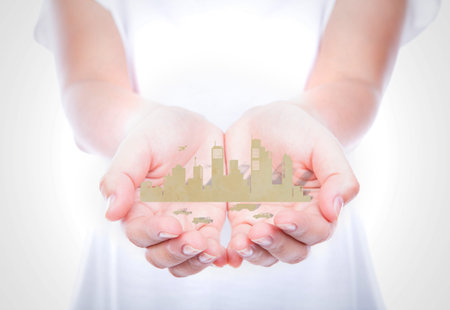 Woman hands hold paper cut of city over body isolated on background.
