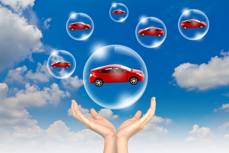 Hand hold Bubbles in the sky with car insideの写真素材