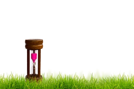 Sand clock in Fresh spring green grass panorama isolated on white background.の写真素材