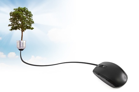 Computer mouse wire into the a lightbulb with treeの写真素材