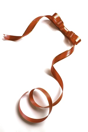 Shiny red ribbon bow on white background with copy space.の写真素材