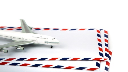 Airmail envelope with model airplaneの写真素材