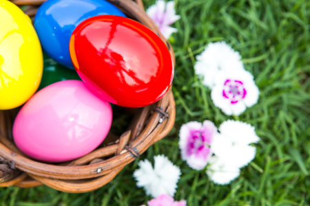 Basket of easter eggs on green grass