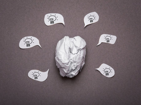 Medical background, Crumpled paper brain shape with light bulb