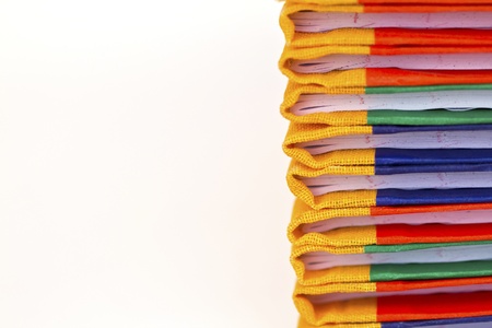 Stack of colorful books on white background, partial view.の写真素材