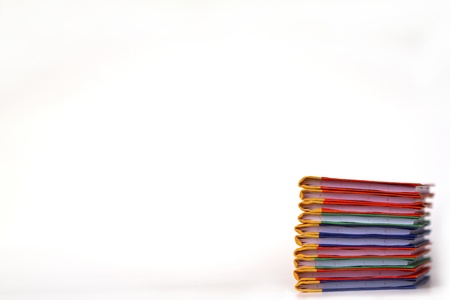 Stack of colorful books on white background, partial view.の写真素材
