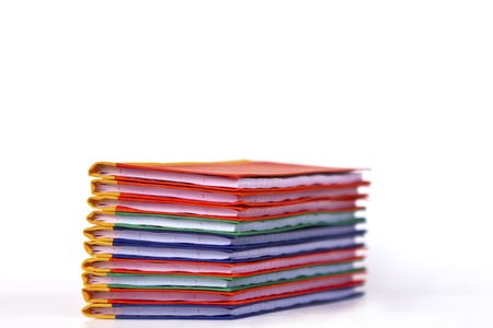 Stack of colorful books on white background, partial view.の写真素材