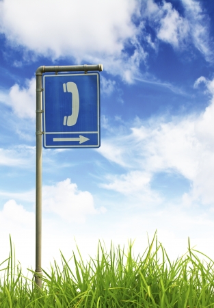 Traffic sign on green grass and blue sky.の写真素材