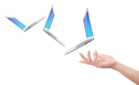 Hand holding laptop isolated on white backgroundの写真素材