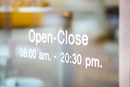 Open and Closed Sign on glass doorの写真素材