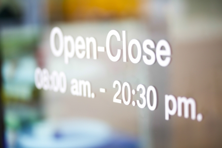 Open and Closed Sign on glass doorの写真素材