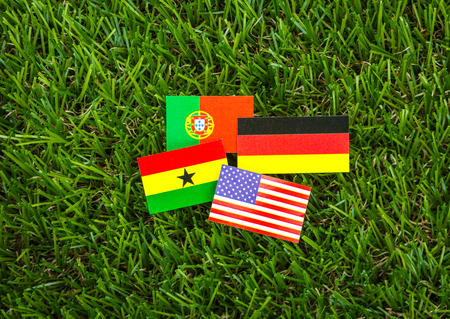 Paper cut of flags on grass for Soccer championship 2014 , group Gの写真素材